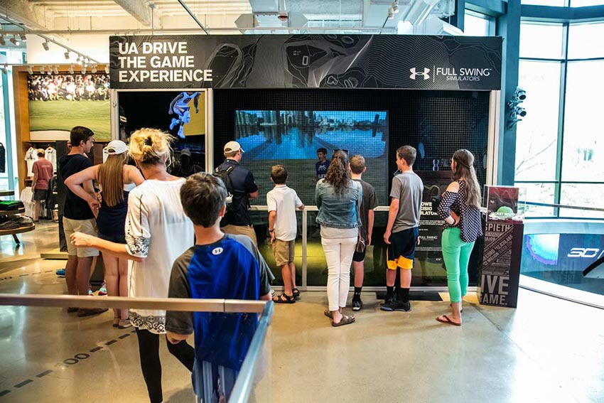 People Waiting to Try the Golf Simulator People Waiting to Try the Golf Simulator